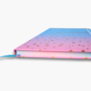 Close-up of gold foil notes and ideas lettering on blue pink ombre notebook