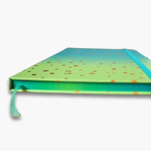 Close-up of gold foil notes and ideas lettering on turquoise green ombre notebook