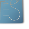 Close-up of gold foil NOTES text on blue notebook