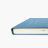 Side angle view of blue A5 hardcover notebook