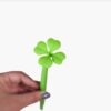 Close-up of the four-leaf clover topper on the pen.