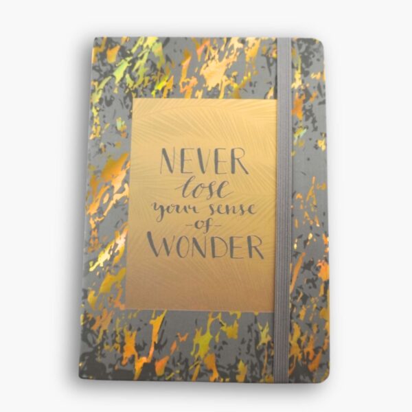Grey hardcover A5 notebook with gold translucent text: “Never lose your sense of wonder.”