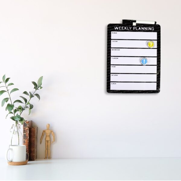 Board with marker and magnets on desk or wall.
