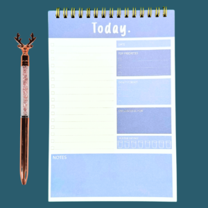 Blue A5 daily planner notepad ring-bound with sections for date, top 3 priorities, don’t forget, gratitude, water intake, to-do, and notes