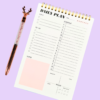 Pink A5 daily planner notepad ring-bound with sections for date, top 3 priorities, to-do, notes, schedule, meal planner, and water intake