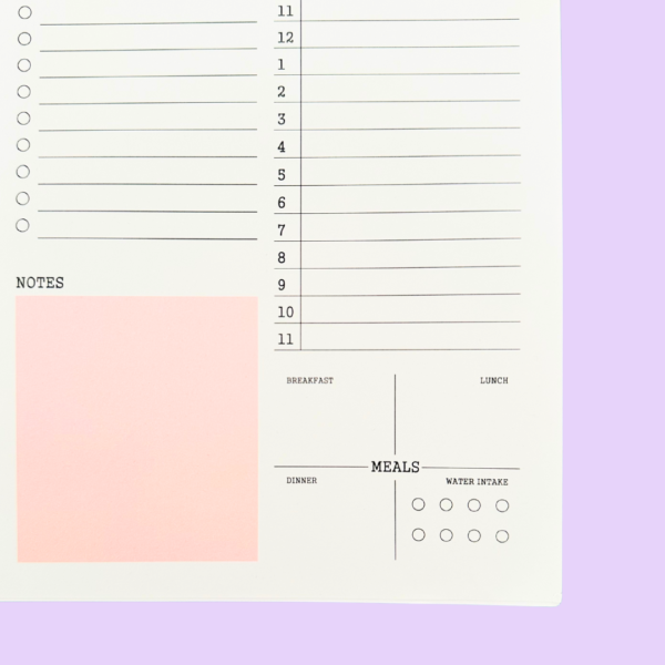 Close-up of pink A5 daily planner meal and water intake tracker